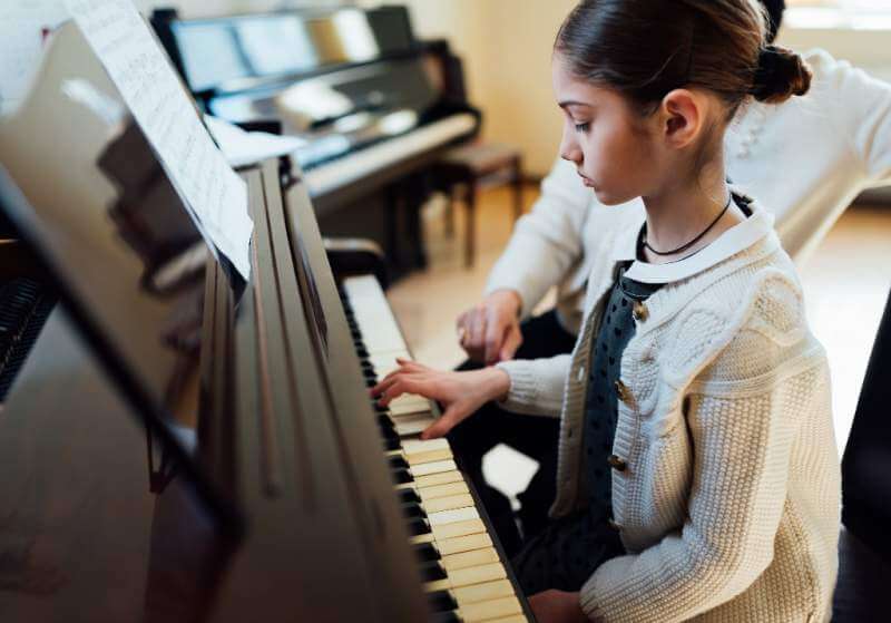 music-teacher-with-the-pupil-at-lesson-piano