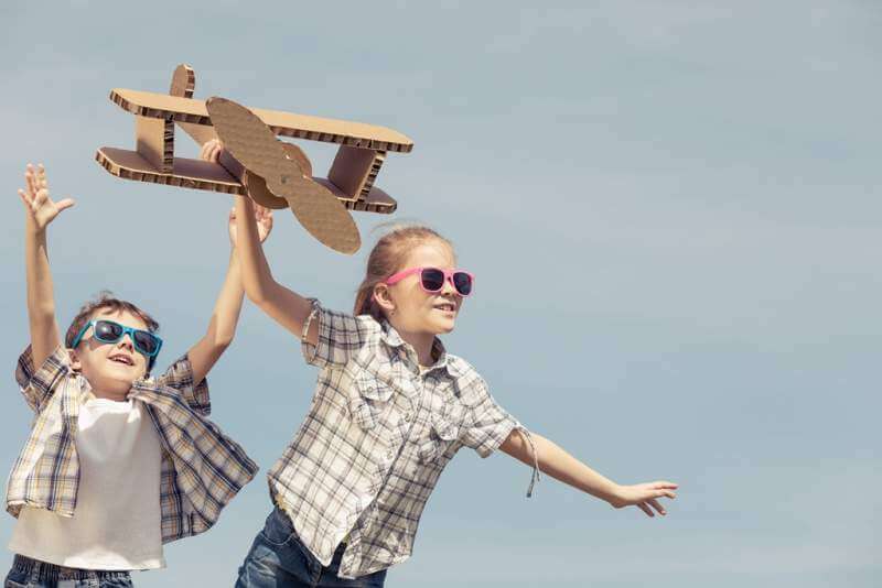 little-kids-playing-with-cardboard-toy-airplane