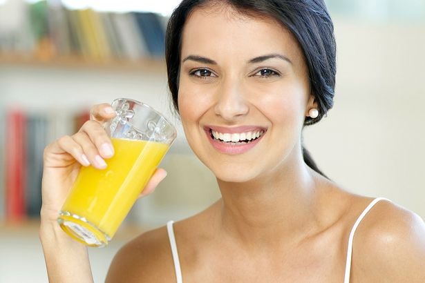 Woman drinking orange juice