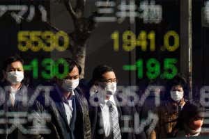 men in front of stock ticker