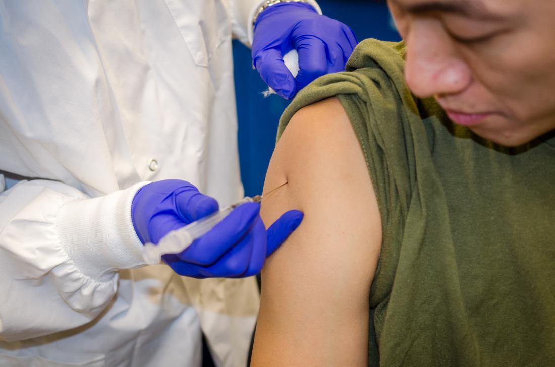 Man getting HPV vaccine in shoulder