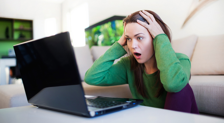 woman shocked looking at laptop, breakup tips, healthista.com.jpg