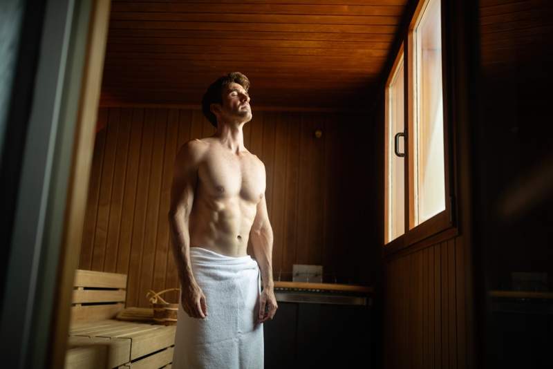 smiling-man-having-a-sauna-bath-in-a-steam-room