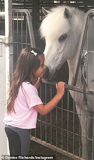 Those with Chromosome 8 deletion often have facial features including a small head and low-set eyes as well as a delay in motor skills and difficulty with speech. Pictured: Eloise with her horse Hansel