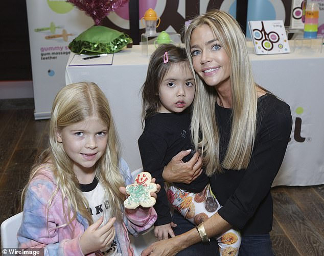 Richards said she knew something was wrong when Eloise was late in reaching developmental milestones including crawling and walking. Pictured: Richards (right) with daughters Lola (left) and Eloise (center) in December 2013