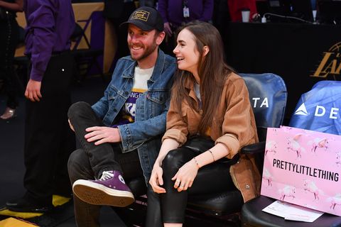 Celebrities At The Los Angeles Lakers Game los angeles, california   january 13 lily collins and charlie mcdowell attend a basketball game between the los angeles lakers and the cleveland cavaliers at staples center on january 13, 2020 in los angeles, california photo by allen berezovskygetty images